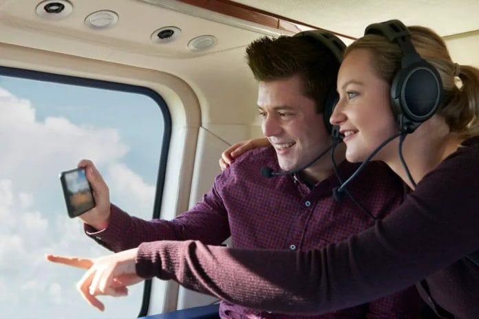 Couple On Vacation Taking Ride In Helicopter